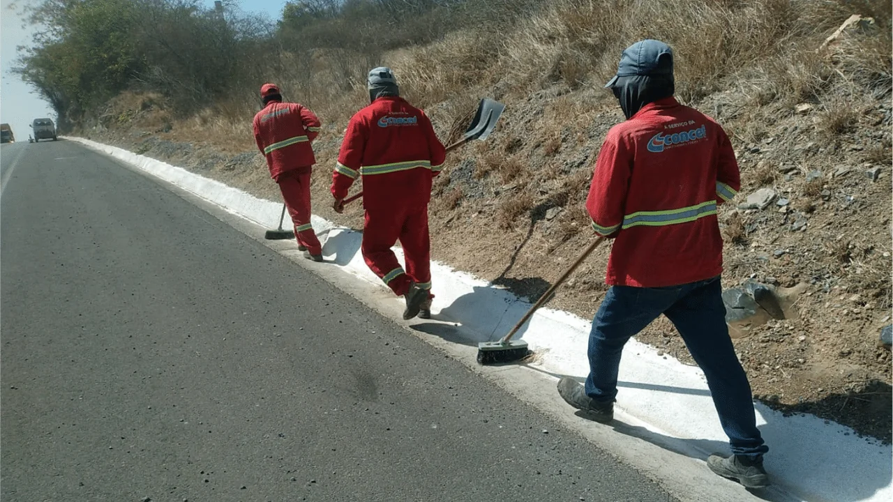 Equipe executando limpeza de sarjetas na BA-052